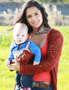 a woman holding a baby in her arms