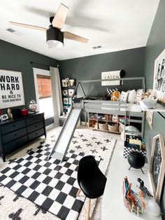 a bedroom with a black and white checkered rug, bunk bed, and play area