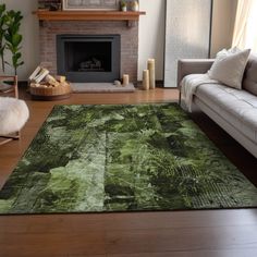 a living room with a couch, fireplace and rug on the floor in front of it