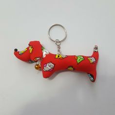 a red dog keychain with cartoon characters on it