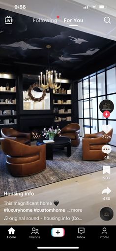 a living room filled with furniture and a chandelier hanging from the ceiling in front of a large window