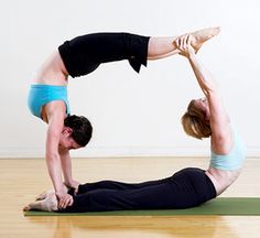 two people are doing yoga on the floor