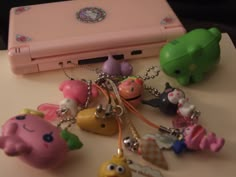 a bunch of toys that are sitting on a table next to a laptop computer and keychain