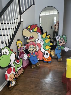 the nintendo characters are lined up on the floor in front of the stair railings