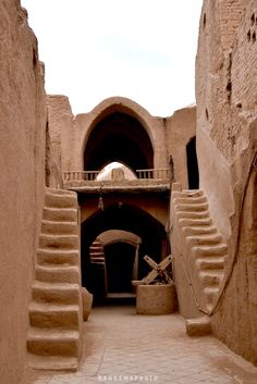 the stairs lead up to an entrance into a building that has been built in adobe style