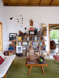 a living room filled with furniture and bookshelves