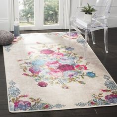 a white rug with pink and blue flowers on it