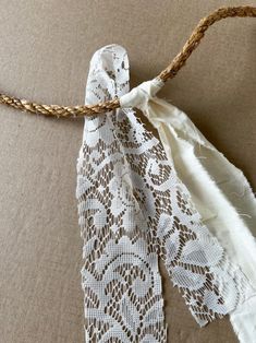 a piece of white lace tied to a string