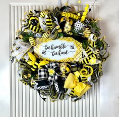 a yellow and black bee wreath with the words eat humble be kind on it