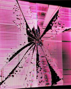 an image of a broken screen with pink light coming through it and the background is blurry