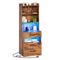 a tall wooden bookcase with drawers and lights on the bottom shelf is holding an electronic device