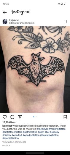 a bat tattoo on the side of a woman's stomach