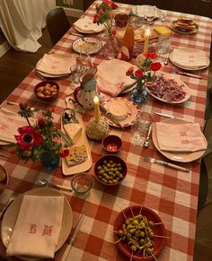 the table is set with plates, bowls and utensils