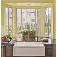 a kitchen with an oven, sink and large window in it's center area