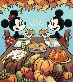 two mickey mouses sitting at a table with thanksgiving food