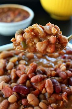 a spoon full of beans and other food