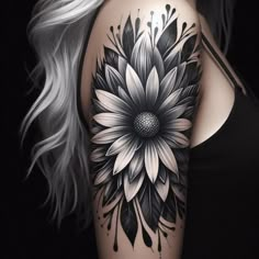 a woman's shoulder with a black and white flower tattoo on her left arm