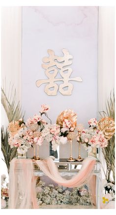 an altar decorated with flowers and decorations for a chinese wedding or special occasion in pink, gold and white