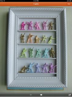 a white frame with some small toy figurines in it