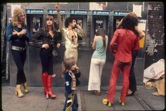 a group of people standing next to each other on a train platform near a subway