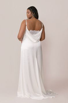 A new favorite making a dramatic statement! The Nadia Bridal Gown has a slight empire waist to help provide a flattering fit for all body types and is finished off with a modest cowl neck, an exaggerated swoop back with a chic peek-a-boo lace detail, and a skirt train.  The Nadia Gown is our Regular Maxi length: 46 inc