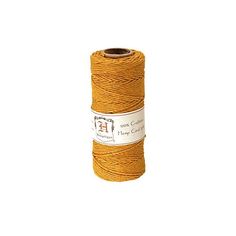 a spool of yellow twine on a white background