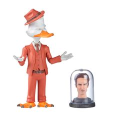 a duck in a suit and hat next to a plastic model of a man under a glass dome