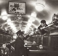 people are sitting on the subway cars in black and white