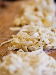 some kind of food that is on a wooden table and ready to be cut into pieces