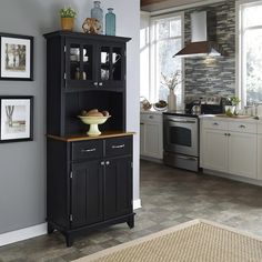 a kitchen with gray walls and white cabinets