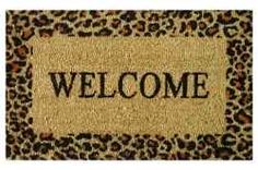 a welcome mat with an animal print border