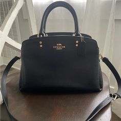 Used A Few Times. Looks Brand New. Elegant Black Bag With Removable Pouch, Luxury Black Satchel With Removable Pouch, Elegant Black Satchel With Detachable Strap, Designer Black Satchel With Detachable Handle, Designer Black Satchel Tote, Elegant Black Satchel With Detachable Handle, Elegant Black Satchel For Everyday Use, Black Formal Bags With Double Handle, Black Double Handle Formal Bag