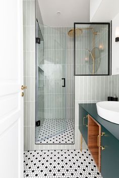 a bathroom with a walk in shower next to a sink