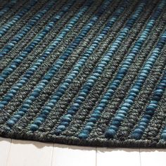 a blue and gray rug on the floor