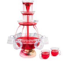 a three tier red glass water fountain with cups and saucers