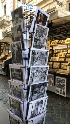 a bunch of pictures are stacked on top of each other in front of a store