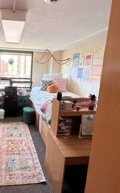 a dorm room with two beds and a rug on the floor in front of it