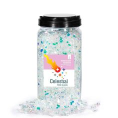 a jar filled with lots of white and blue sprinkles next to a black lid