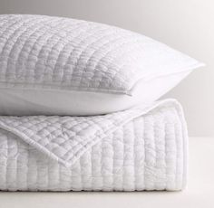 two white pillows stacked on top of each other