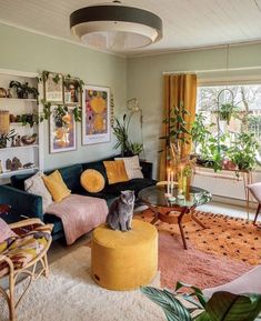 a living room filled with furniture and lots of plants