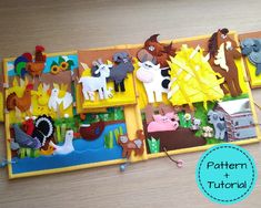 an open book with cut out farm animals on it