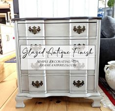 an antique dresser painted white with black lettering