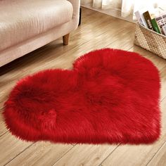 a red heart shaped rug on the floor