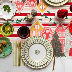 a table topped with plates and christmas decorations