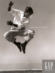 a man is jumping in the air with his feet up