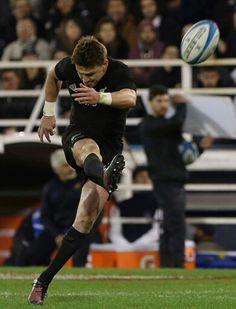 a rugby player kicking the ball during a game