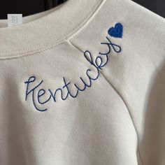 Bella Canvas Embroidered Sweatshirt! Show Your Kentucky Spirit With This Cute Vintage White Embroidered Sweatshirt "Kentucky" With A Heart! -Supersoft Pullover Sweatshirt With Ribbed Cuffs -Relaxed Fit -Falls Right At The Hip -52% Airlume Cotton, 48% Polyester Fleece -Small Fits 30-32" Chest, Medium Fits 32-34" Chest, Large Fits 36-38" Chest Cream Cotton Tops With Letter Embroidery, Cream Cotton Top With Letter Embroidery, Embroidery Sweatshirt Designs, Machine Embroidered Gifts, Reverse Applique Sweatshirt, Patch Work Sweatshirt, Diy Embroidery Letters, Embroidered College Sweatshirt, Lake Sweatshirt