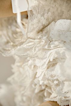 the back of a wedding dress hanging on a hanger