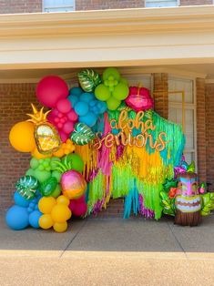 an entrance to a building decorated with balloons and streamers