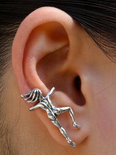 a close up of a person's ear with a skeleton design on the side